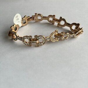 Gold plated horse shoe equestrian style bracelet.